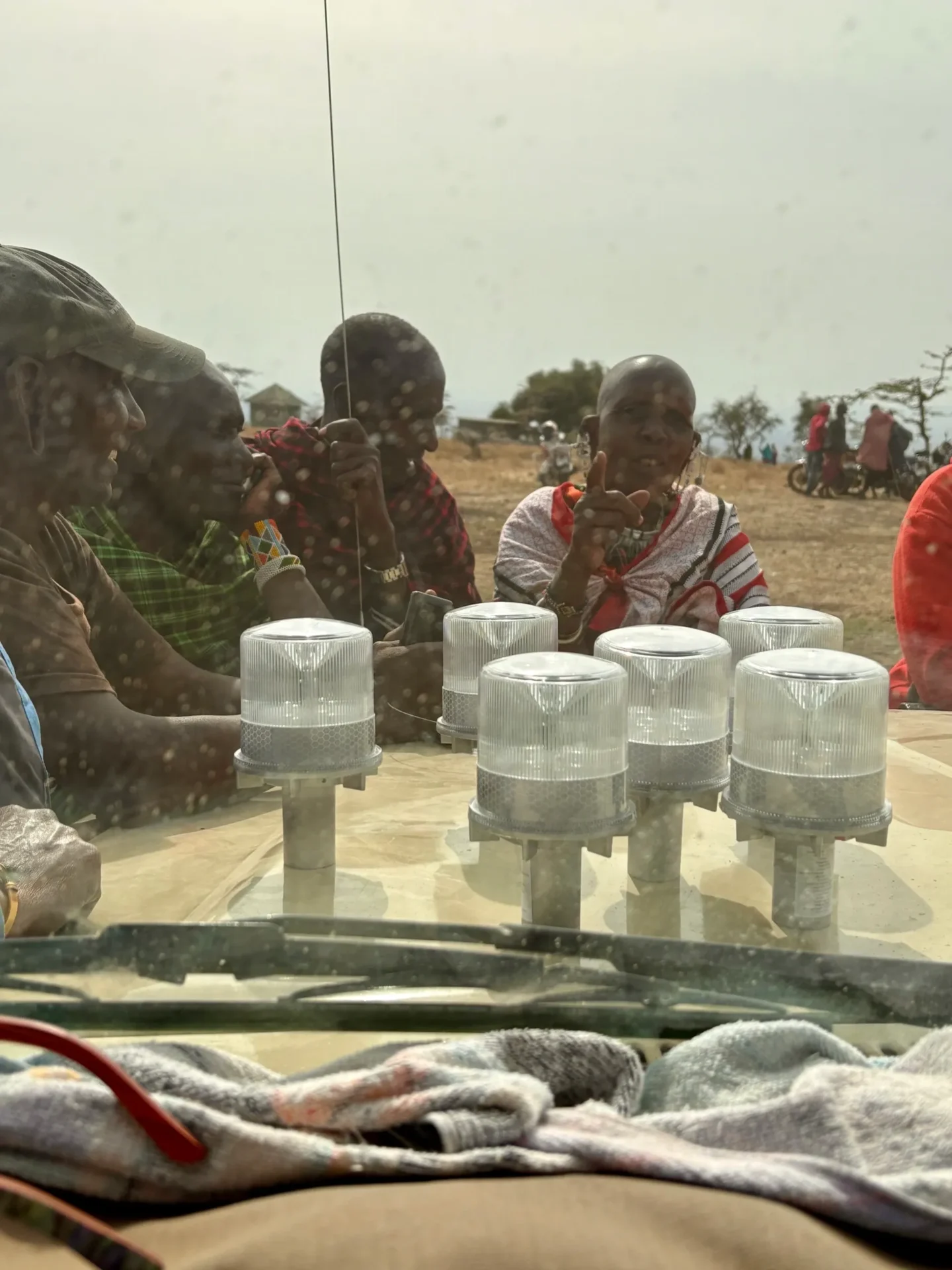 People gathered around solar-powered lights outdoors.