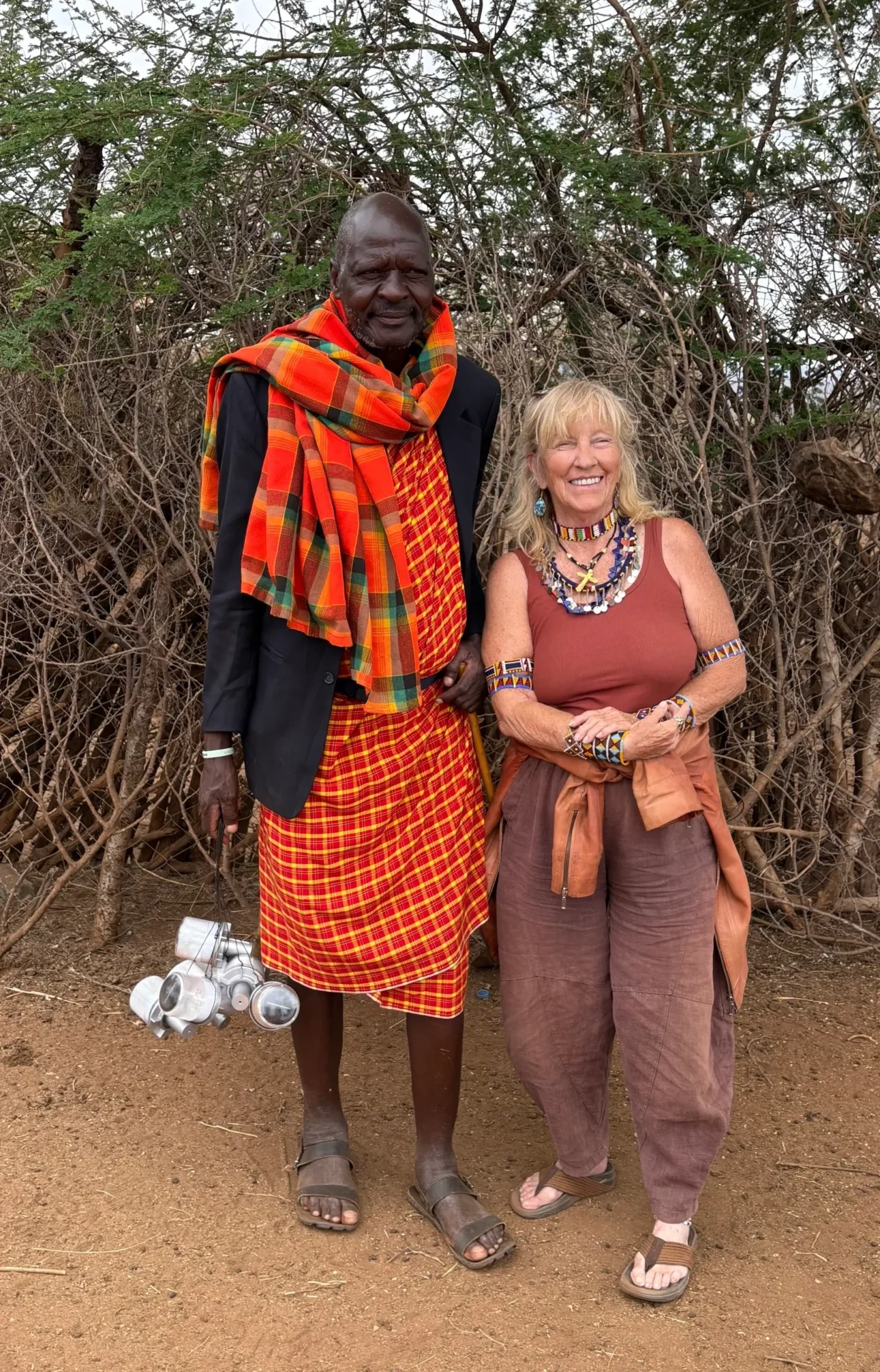 Man and woman smiling in traditional attire.